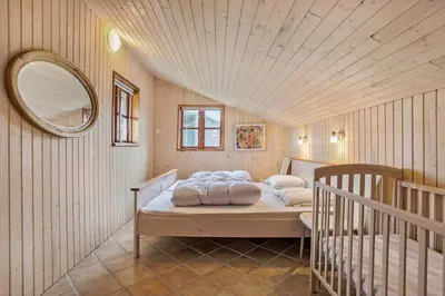 a bedroom with two beds and a round mirror at JB144-Frostrup-Horsbakkevej-7 in Frøstrup