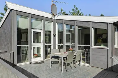 a screened in deck with a table and chairs at JB759-Fjerritslev-Revlingestien-45 in Fjerritslev