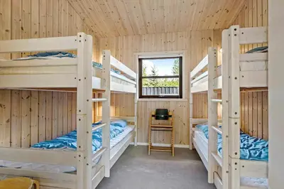 a bedroom with four bunk beds in a cabin at JB828-Fjerritslev-Revlingestien-71 in Fjerritslev
