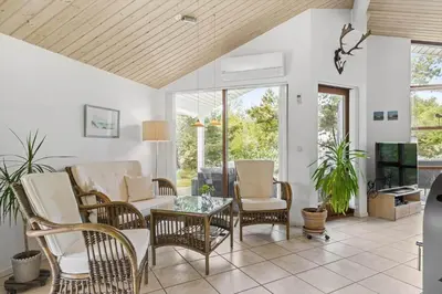 a living room with wicker chairs and a tv at JB828-Fjerritslev-Revlingestien-71 in Fjerritslev
