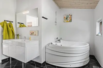 a white bathroom with a tub and a sink at JB828-Fjerritslev-Revlingestien-71 in Fjerritslev