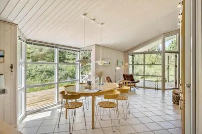 a kitchen and dining room with a table and chairs at JB696-Fjerritslev-Blabaerstien-56 in Fjerritslev