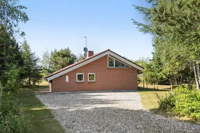 a red brick house on a gravel driveway at JB304-Fjerritslev-Landstien-4 in Fjerritslev