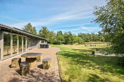 a patio with a table and benches in a field at JB182-Fjerritslev-Gyvelstien-39 in Fjerritslev