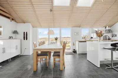a kitchen and dining room with a table and chairs at JB203-Brovst-Kronvildtvej-35 in Brovst