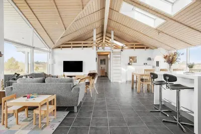 a living room with a couch and a table at JB203-Brovst-Kronvildtvej-35 in Brovst