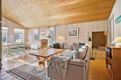 a living room with a couch and a table at JB122-Fjerritslev-Tyttebaerstien-14 in Fjerritslev