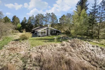 a house on a grassy hill with a house at JB154-Fjerritslev-Bredvandet-34 in Fjerritslev