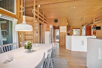 a kitchen and dining room with a white table and chairs at JB154-Fjerritslev-Bredvandet-34 in Fjerritslev