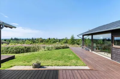 a house with a deck with a view of a yard at JB177-Fjerritslev-Aspevej-44 in Fjerritslev