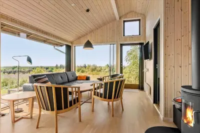a living room with a couch and a table and chairs at JB177-Fjerritslev-Aspevej-44 in Fjerritslev