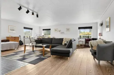 a living room with a couch and a table and chairs at JB325-Frostrup-Bulbjergvej-40 in Frøstrup