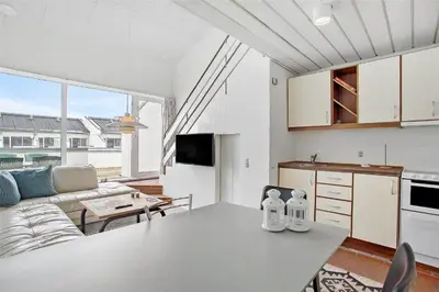 a kitchen and a living room with a table at JB129-Brovst-Strandvejen-150-Lejl-106 in Brovst
