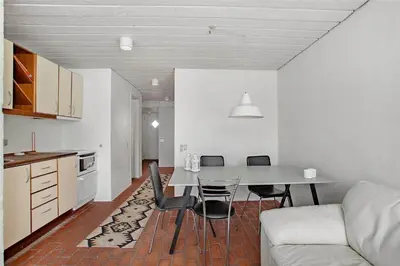 a kitchen and dining room with a table and chairs at JB129-Brovst-Strandvejen-150-Lejl-106 in Brovst