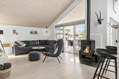 a living room with a couch and a fireplace at JB161-Brovst-Kronvildtvej-206 in Brovst