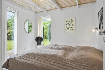 a bedroom with a large bed and a window at JB178-Brovst-Kronvildtvej-3 in Brovst