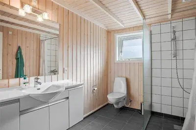 a bathroom with a sink and a toilet and a window at JB133-Fjerritslev-Blabaerstien-35 in Fjerritslev