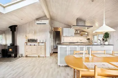 a kitchen with a table and a stove at JB137-Fjerritslev-Markstien-15 in Fjerritslev