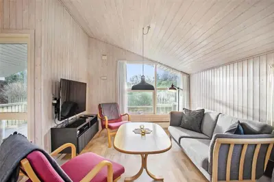 a living room with a couch and a table at JB137-Fjerritslev-Markstien-15 in Fjerritslev