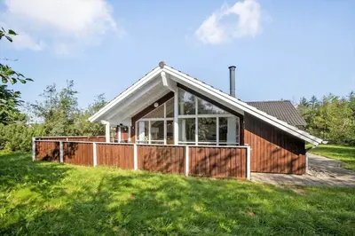 a house on a hill with a fence at JB223-Brovst-Kronvildtvej-18 in Brovst