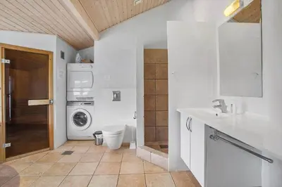 a bathroom with a sink and a washing machine at JB705-Frostrup-Svenstibakkevej-82 in Frøstrup