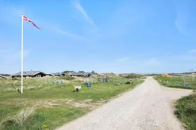 a dirt road next to a field with a kite at JB705-Frostrup-Svenstibakkevej-82 in Frøstrup