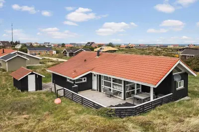 a house with an orange roof on top of a field at JB705-Frostrup-Svenstibakkevej-82 in Frøstrup
