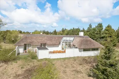 a white house with a roof on top of a field at JB158-Fjerritslev-Lynghojsletten-27 in Fjerritslev