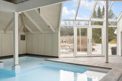 an empty swimming pool in a house with a large window at JB158-Fjerritslev-Lynghojsletten-27 in Fjerritslev