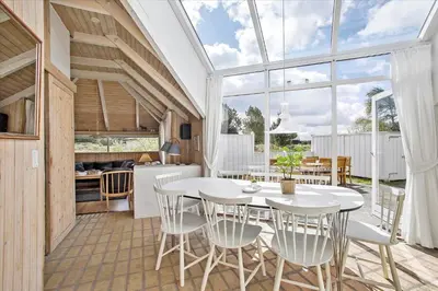 a kitchen and dining room with a white table and chairs at JB158-Fjerritslev-Lynghojsletten-27 in Fjerritslev