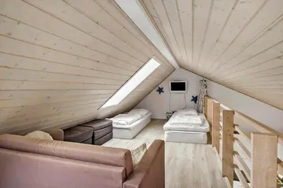 a attic room with two toilets and a couch at JB327-Brovst-Kronvildtvej-140 in Brovst