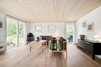 a living room with a couch and a piano at JB205-Fjerritslev-Tyttebaerstien-12 in Fjerritslev