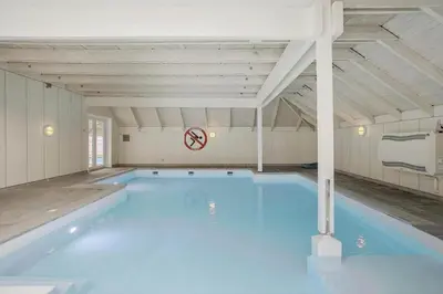 a large swimming pool with blue water in a building at JB628-Fjerritslev-Lynghojsletten-49 in Fjerritslev