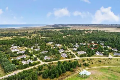 an aerial view of a resort with trees and the ocean at JB628-Fjerritslev-Lynghojsletten-49 in Fjerritslev