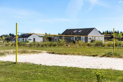 a house in a field next to a beach at JB141-Brovst-Kronvildtvej-86 in Brovst