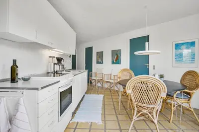 a kitchen and dining room with a table and chairs at JB1108-Frostrup-Strandvejen-67 in Frøstrup