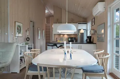 a kitchen and dining room with a white table and chairs at JB283-Frostrup-Andreas-Lassens-Vej-6 in Frøstrup