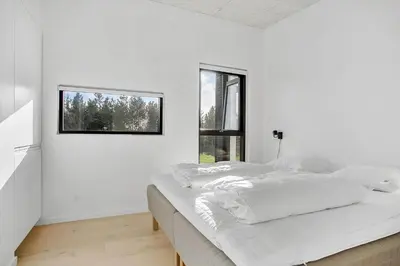 a white bedroom with a bed and a window at JB190-Fjerritslev-Stenhusvej-34-B in Fjerritslev