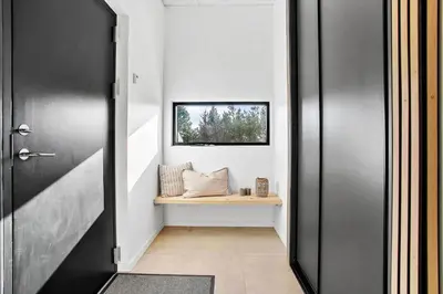 a hallway with a black door and a window at JB190-Fjerritslev-Stenhusvej-34-B in Fjerritslev