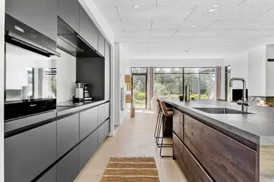 a kitchen with black and white cabinets and a counter at JB190-Fjerritslev-Stenhusvej-34-B in Fjerritslev
