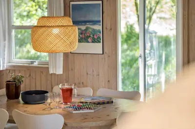 a dining room table with chairs and a lamp at JB291-Fjerritslev-Stenhusvej-30 in Fjerritslev