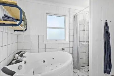 a white bathroom with a tub and a window at JB291-Fjerritslev-Stenhusvej-30 in Fjerritslev