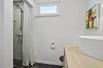 a white bathroom with a shower and a sink at JB908-Brovst-Kronvildtvej-190 in Brovst