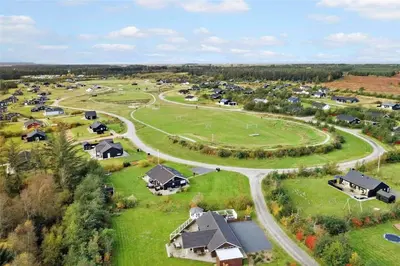an aerial view of a village with houses and a road at JB908-Brovst-Kronvildtvej-190 in Brovst