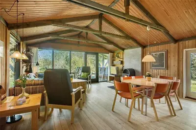 a living room with wooden ceilings and a table and chairs at JB391-Fjerritslev-Perikumvej-62 in Fjerritslev