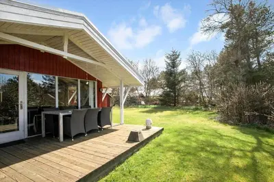 a deck with chairs and a table on a house at JB391-Fjerritslev-Perikumvej-62 in Fjerritslev