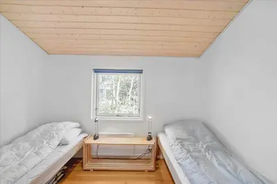 two beds in a room with a window at JB167-Fjerritslev-Revlingestien-83 in Fjerritslev