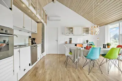 a kitchen and dining room with a table and chairs at JB169-Brovst-Kronvildtvej-126 in Brovst