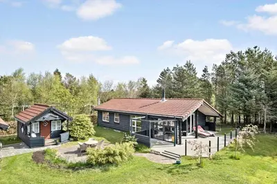 a home with a large yard and a house at JB314-Fjerritslev-Tyttebaerstien-13 in Fjerritslev