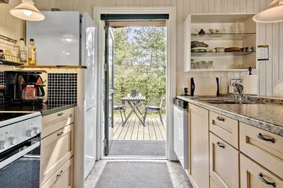 a kitchen with a door leading to a patio at JB314-Fjerritslev-Tyttebaerstien-13 in Fjerritslev